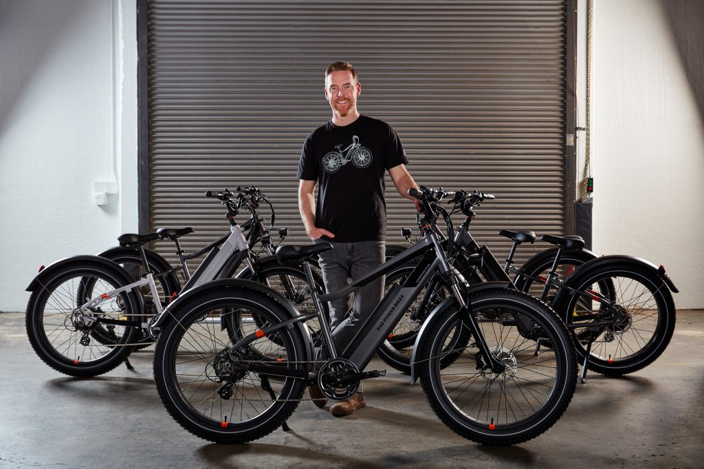 Mike Radenbaugh, founder of Rad Power Bikes, pictured with some e-bikes