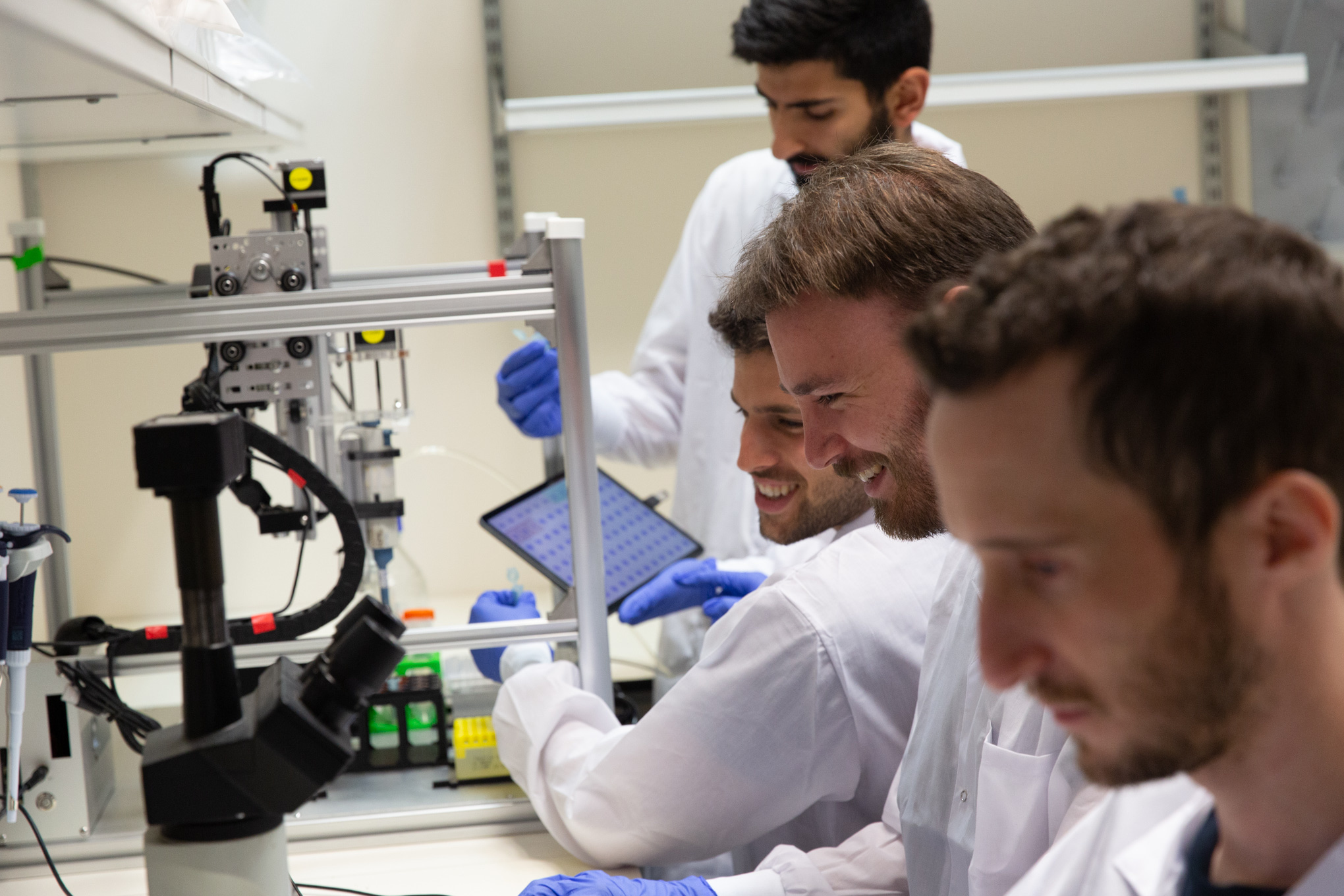 Members of the Quris team work in a lab.
