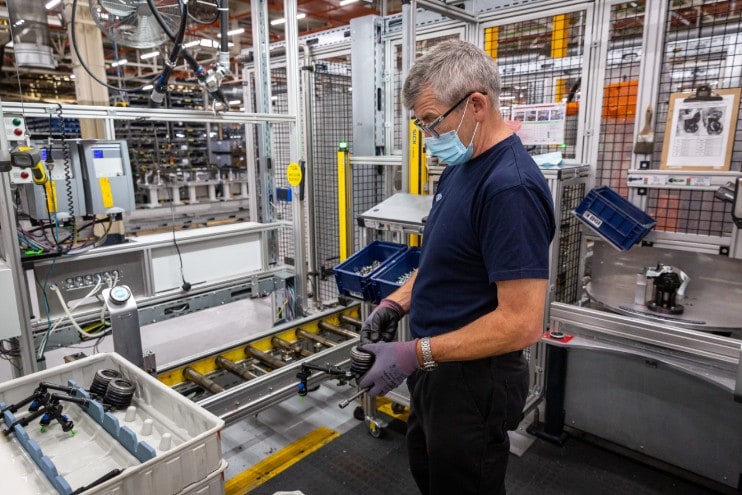 Worker at Ford Halewood UK facility makes power units