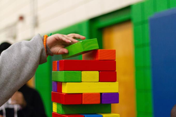 a child stacking colored blocks