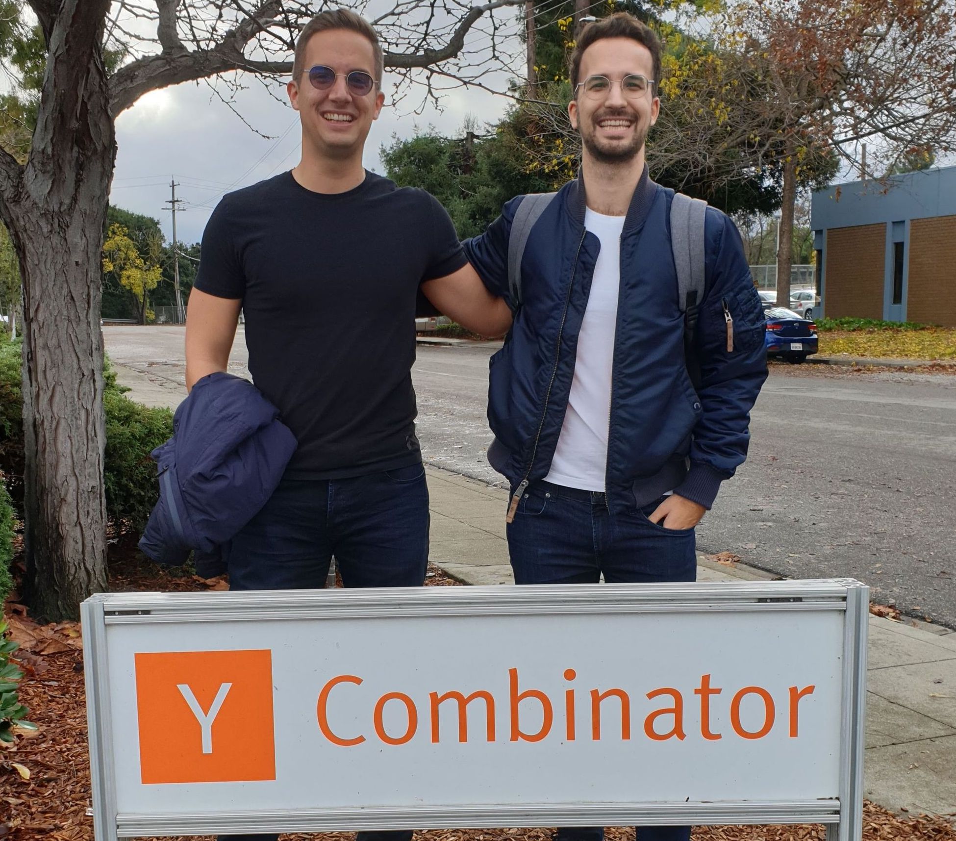 Wasp founders Martin and Matija Sosic standing behind Y Combinator sign