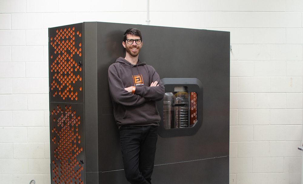 David Moodie, cofounder and ceo of Foundry Lab, in front of microwave used to make metal castings for prototypes