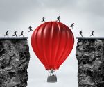 red balloon with man helping people cross chasm