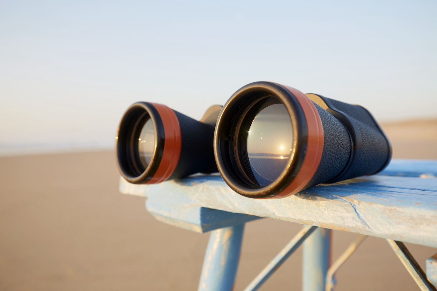 Close-up of binoculars on table by the sea during sunset, the sunset is reflected in the glass of the binoculars (Close-up of binoculars on table by the sea during sunset, the sunset is reflected in the glass of the binoculars, ASCII, 113 components,