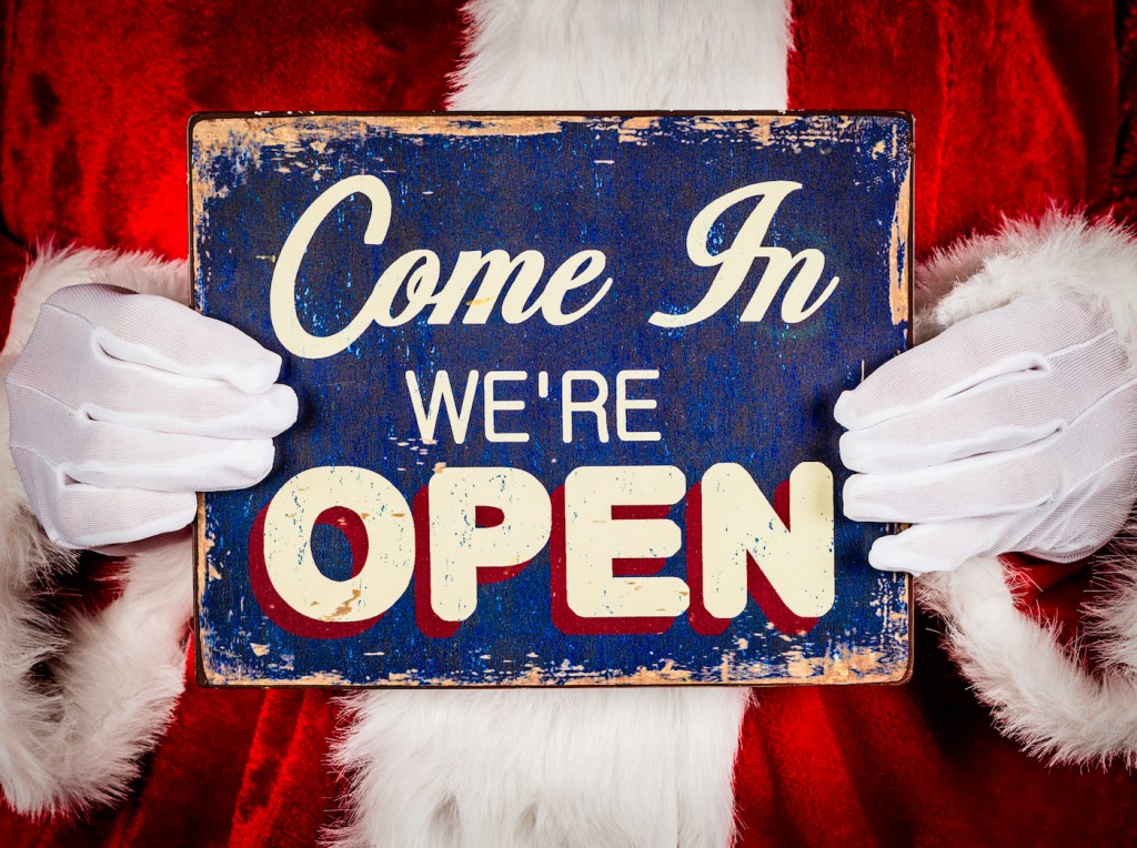 Santa with Sign promoting store being open