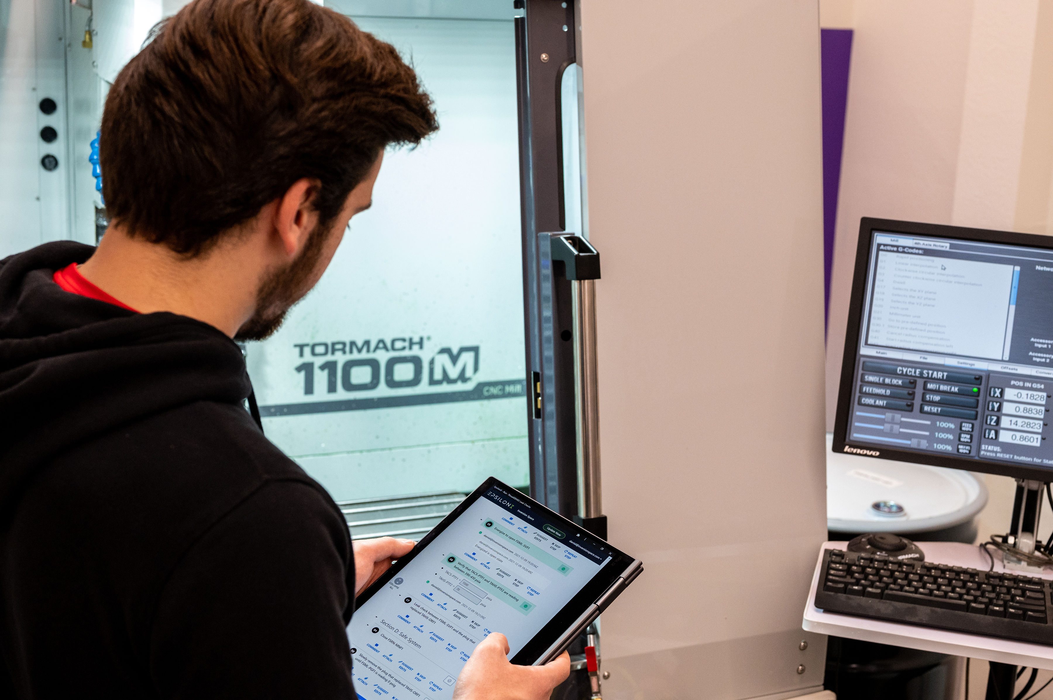 An Epsilon3 employee compares data from tests on multiple screens.