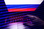 Russian flag displayed on a laptop screen and binary code code displayed on a screen are seen in this multiple exposure illustration photo