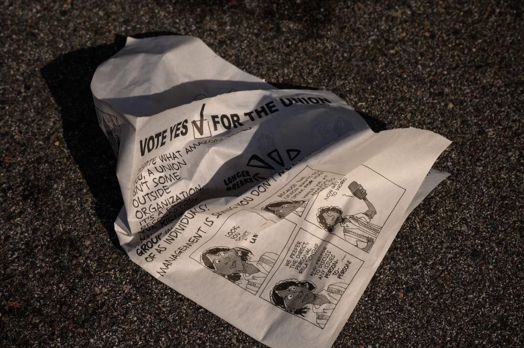 A leaflet is discarded as workers make their way to cast their vote over whether or not to unionize, outside an Amazon warehouse in Staten Island on March 25, 2022