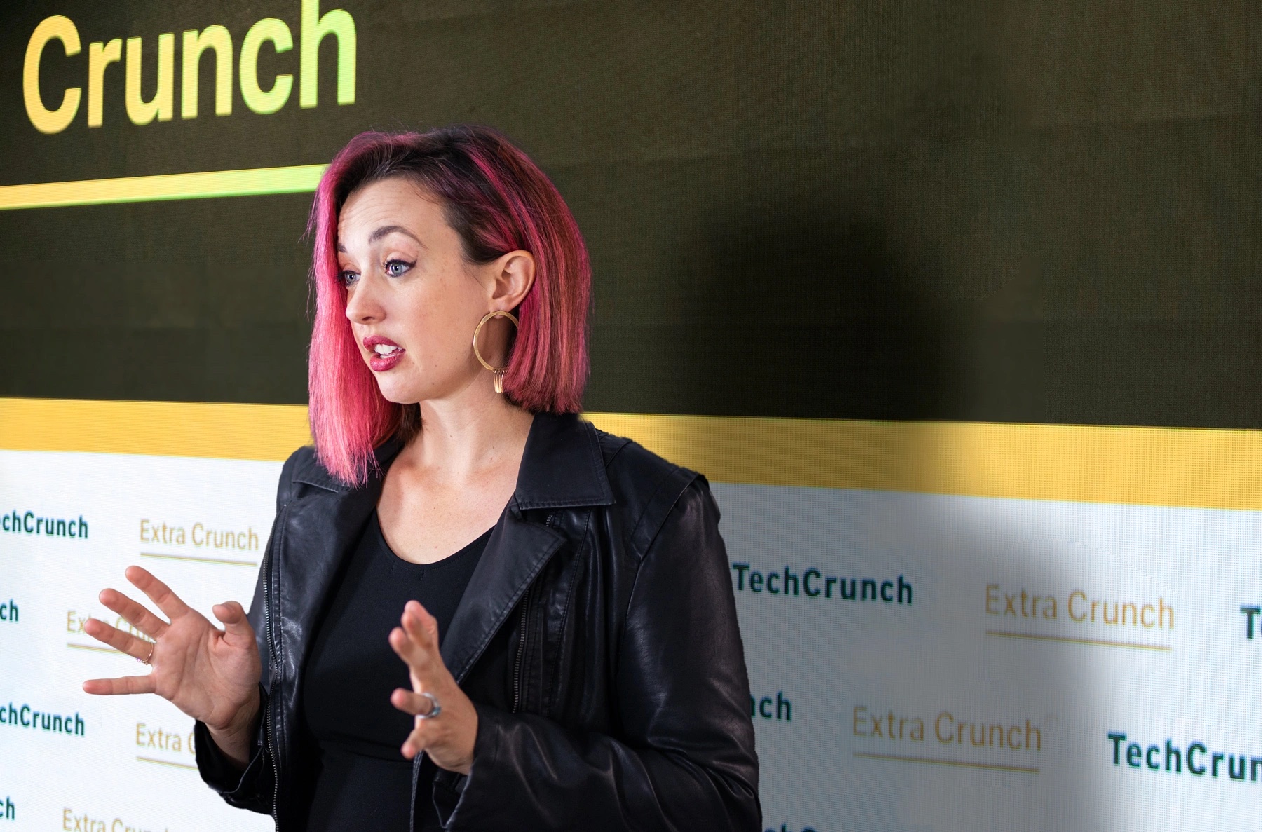 A composite image of immigration law attorney Sophie Alcorn in front of a background with a TechCrunch logo.