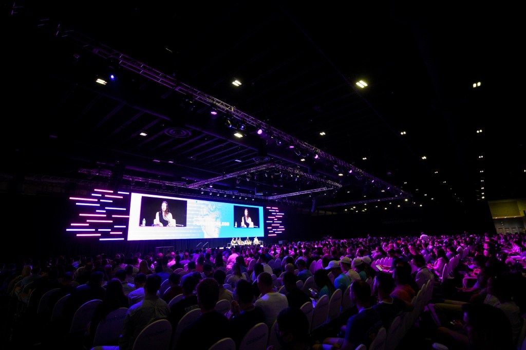 A photograph of a room of people listening to the main stage at Permissionless in West Palm Beach on May 17 at the Blockworks, Bankless co-hosted conference.