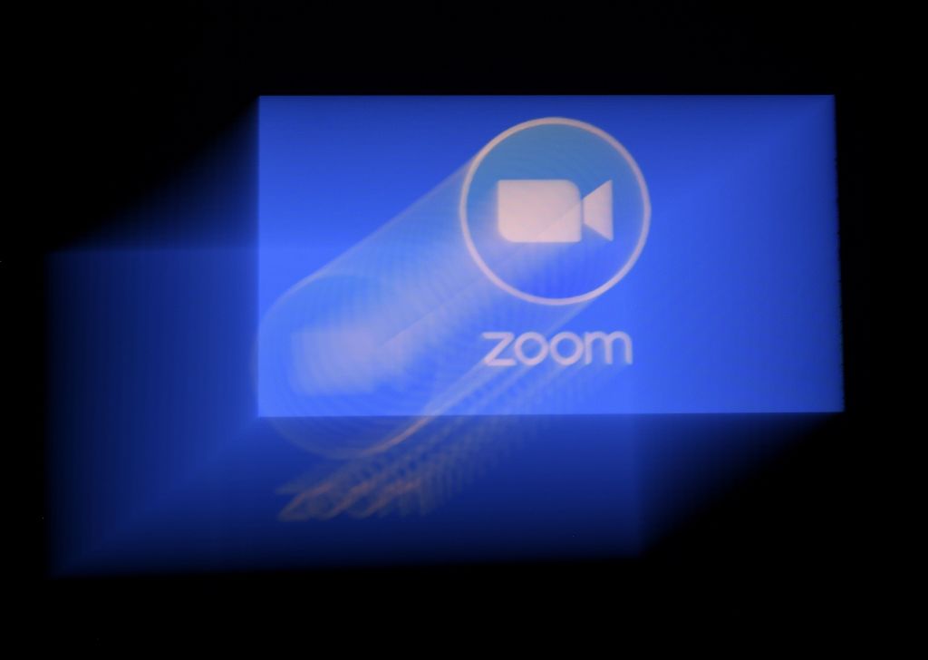 In this photo illustration a Zoom App logo is displayed on a smartphone on March 30, 2020 in Arlington, Virginia. - The Zoom video meeting and chat app has become the wildly popular host to millions of people working and studying from home during the coronavirus outbreak. (Photo by Olivier DOULIERY / AFP) (Photo by OLIVIER DOULIERY/AFP via Getty Images)