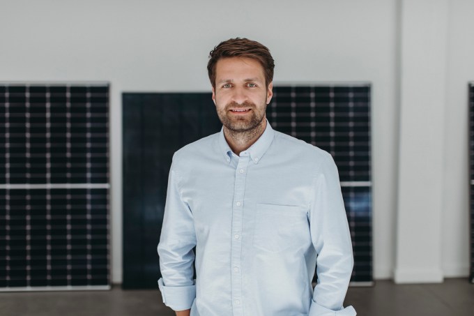 zolar founder and CEO Alex Melzer pictured in front of some solar panels