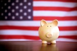 piggy bank in front of american flag. government spending in tech
