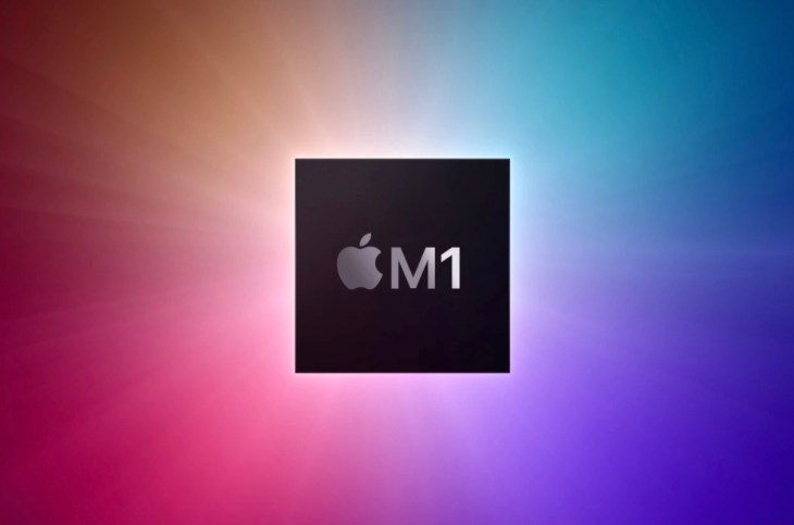 A photo of Apple's M1 chip on a multicolored background.