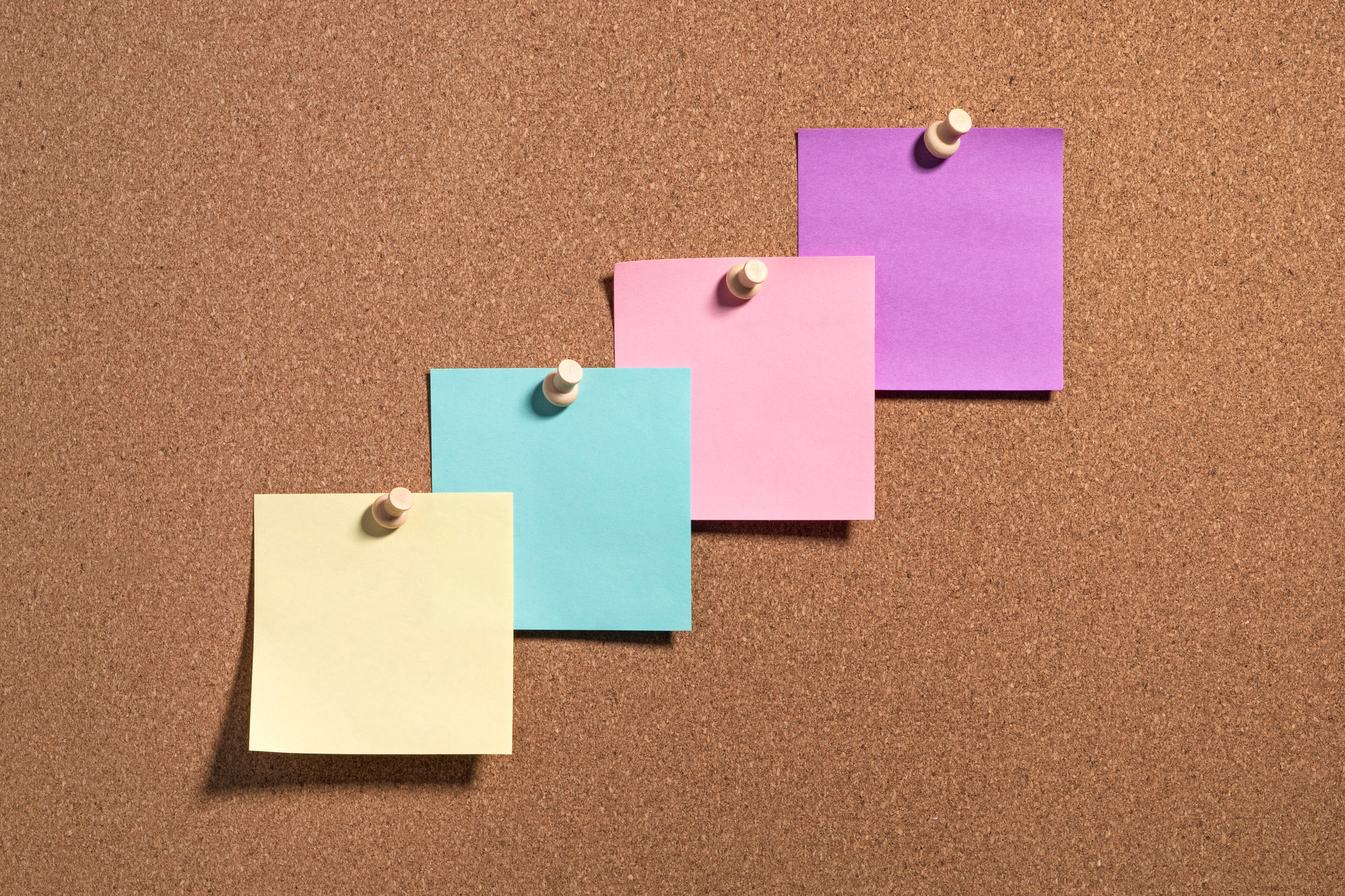 4 sticky notes on a cork board; Topics of conversation for investor negotiations