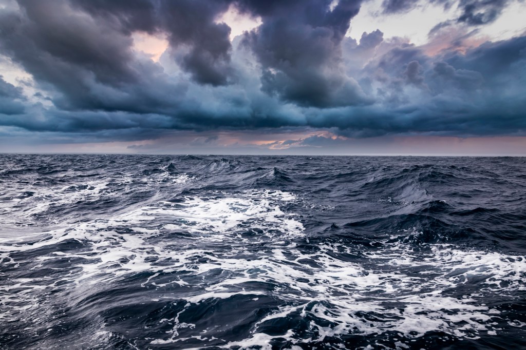 Storm on the sea with dramatic clouds at sunset