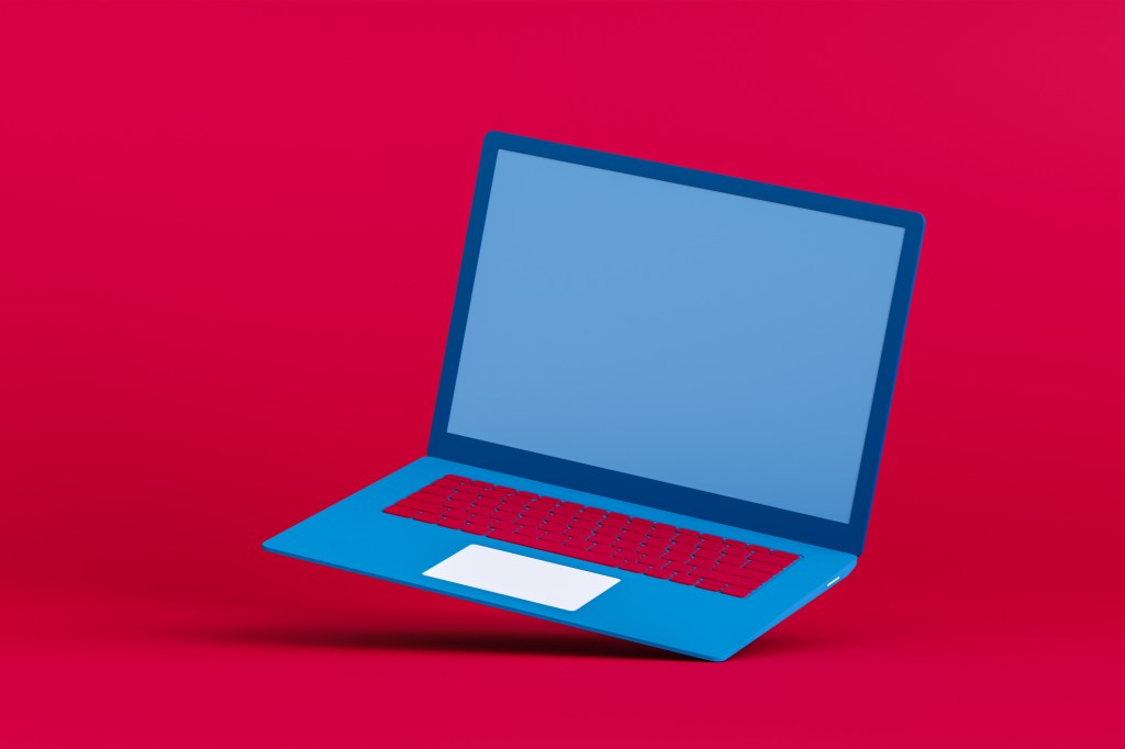 Blue laptop on a red background