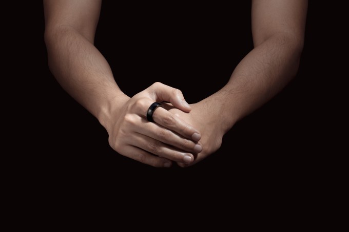 Ultrahuman Ring, black coloring, shown worn on human hands