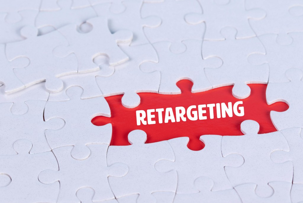 Illustration of white jigsaw pieces with the word retargeting highlighted in red