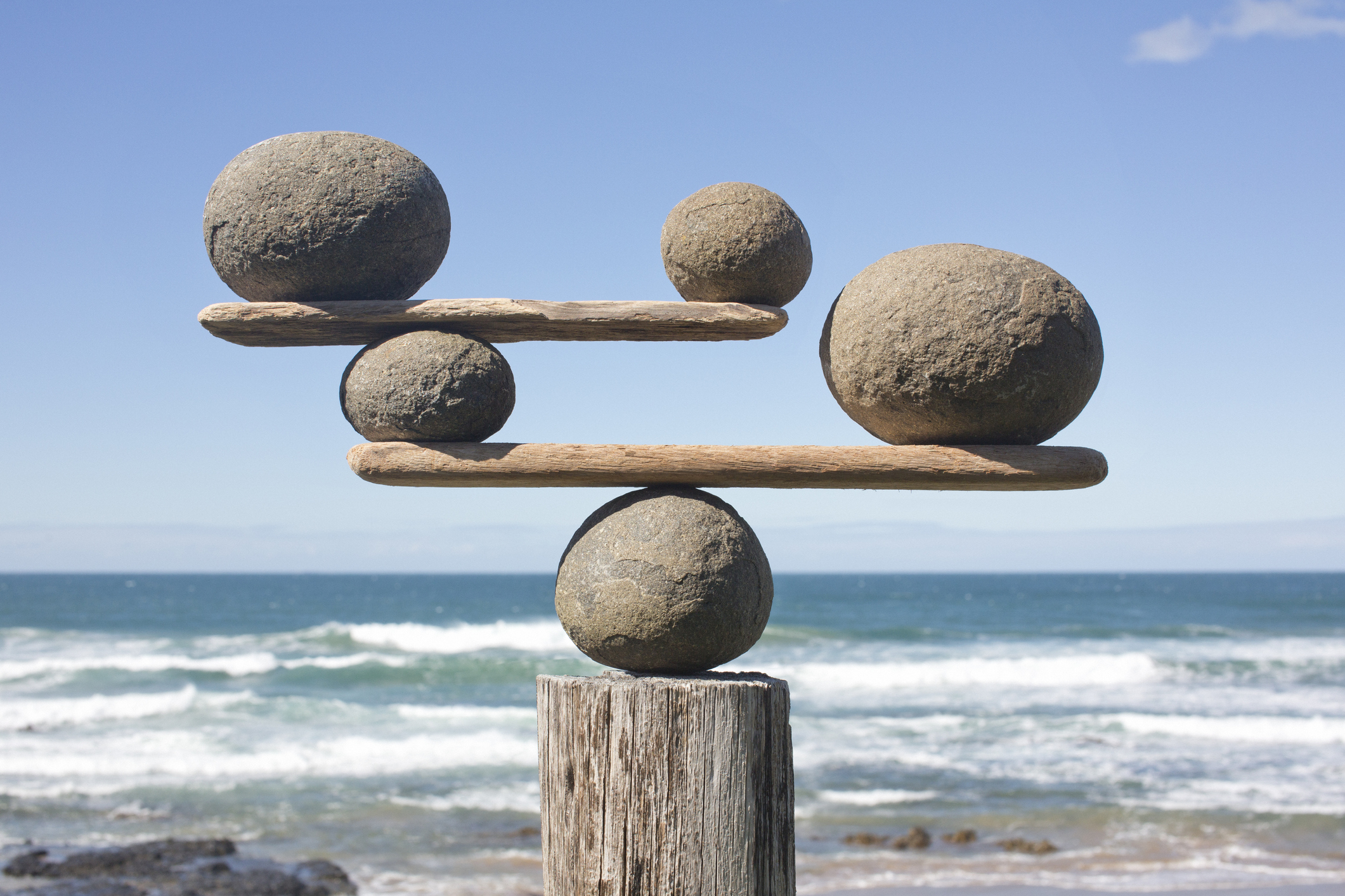 Rocks balancing on driftwood, sea in background; building an MVP without technical background