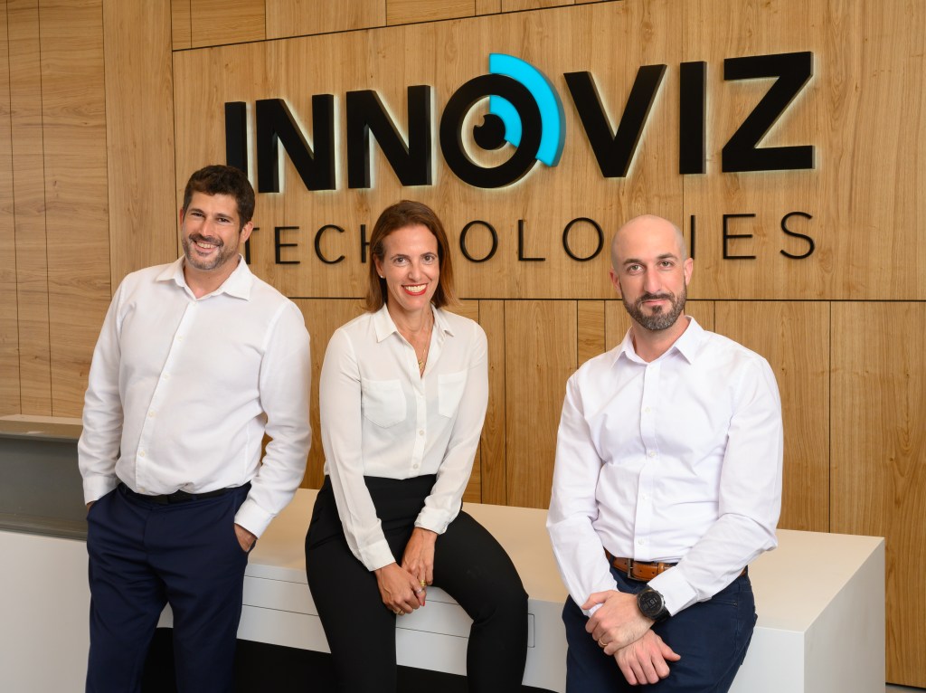 Innoviz management team - two men and one woman lined up in front of sign that says innoviz technologies