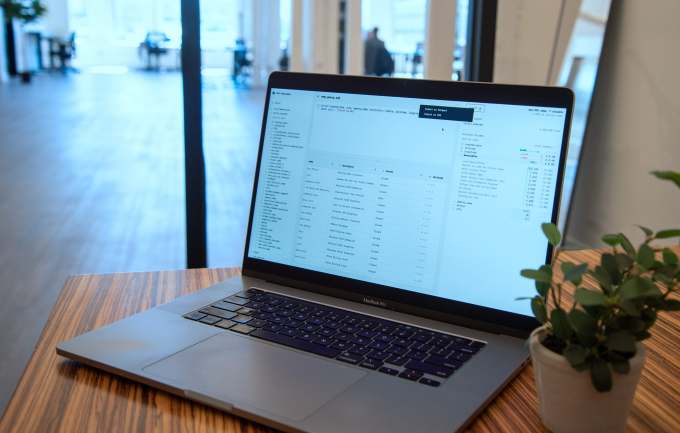 A real app sits on a desktop in an office on a MacBook Pro.