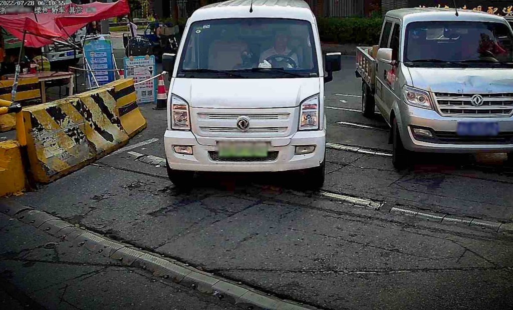 A photo of a vehicle entering a car park in China.