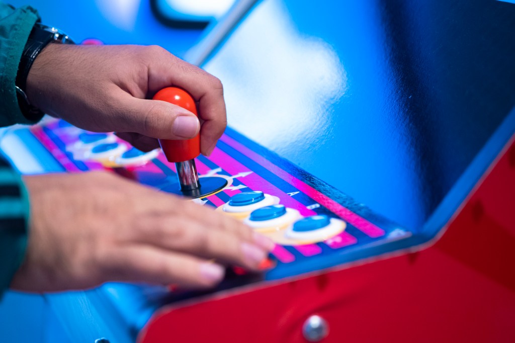 Close up shot of person playing with a arcade machine