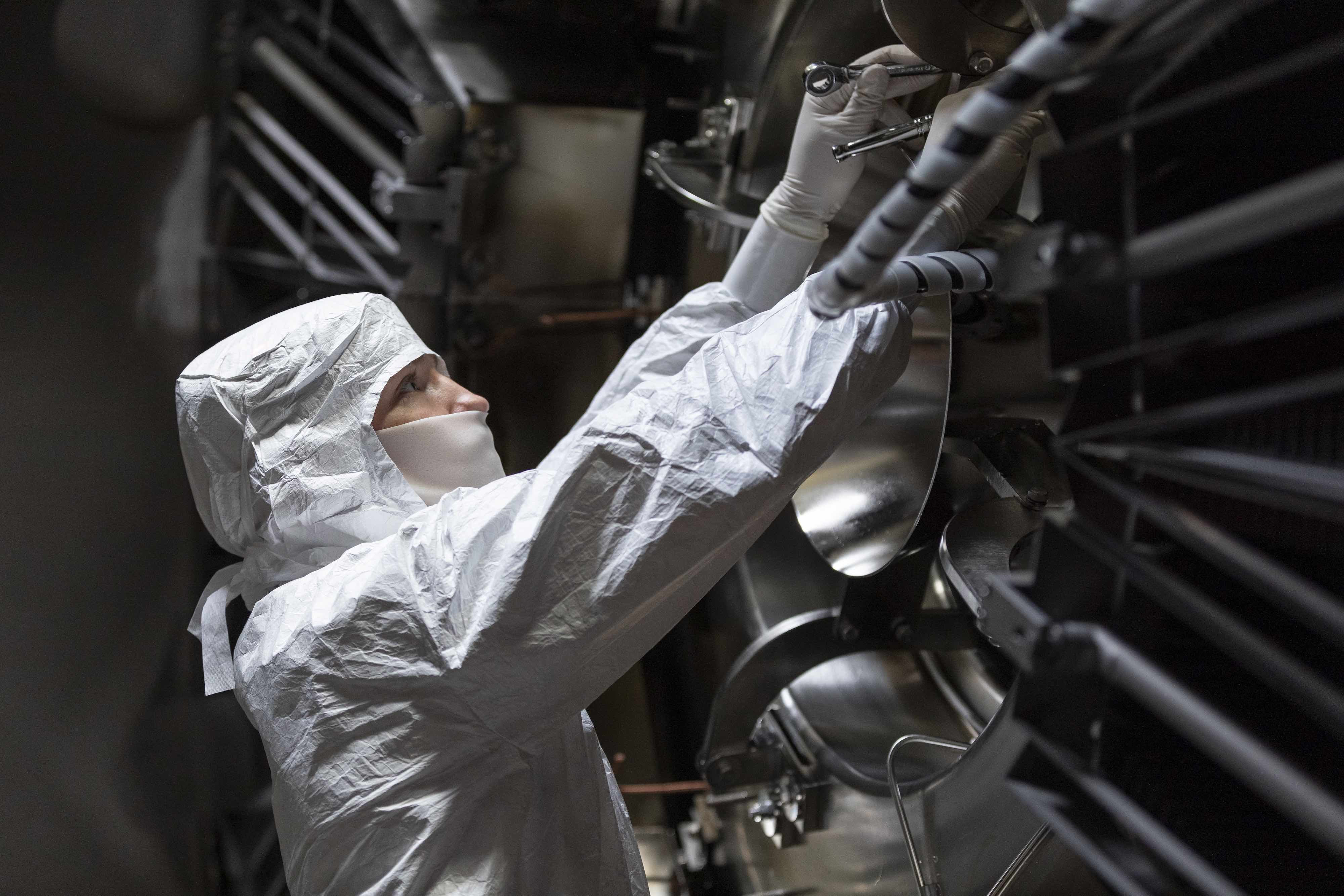A technician working inside TAE's Norman reactor