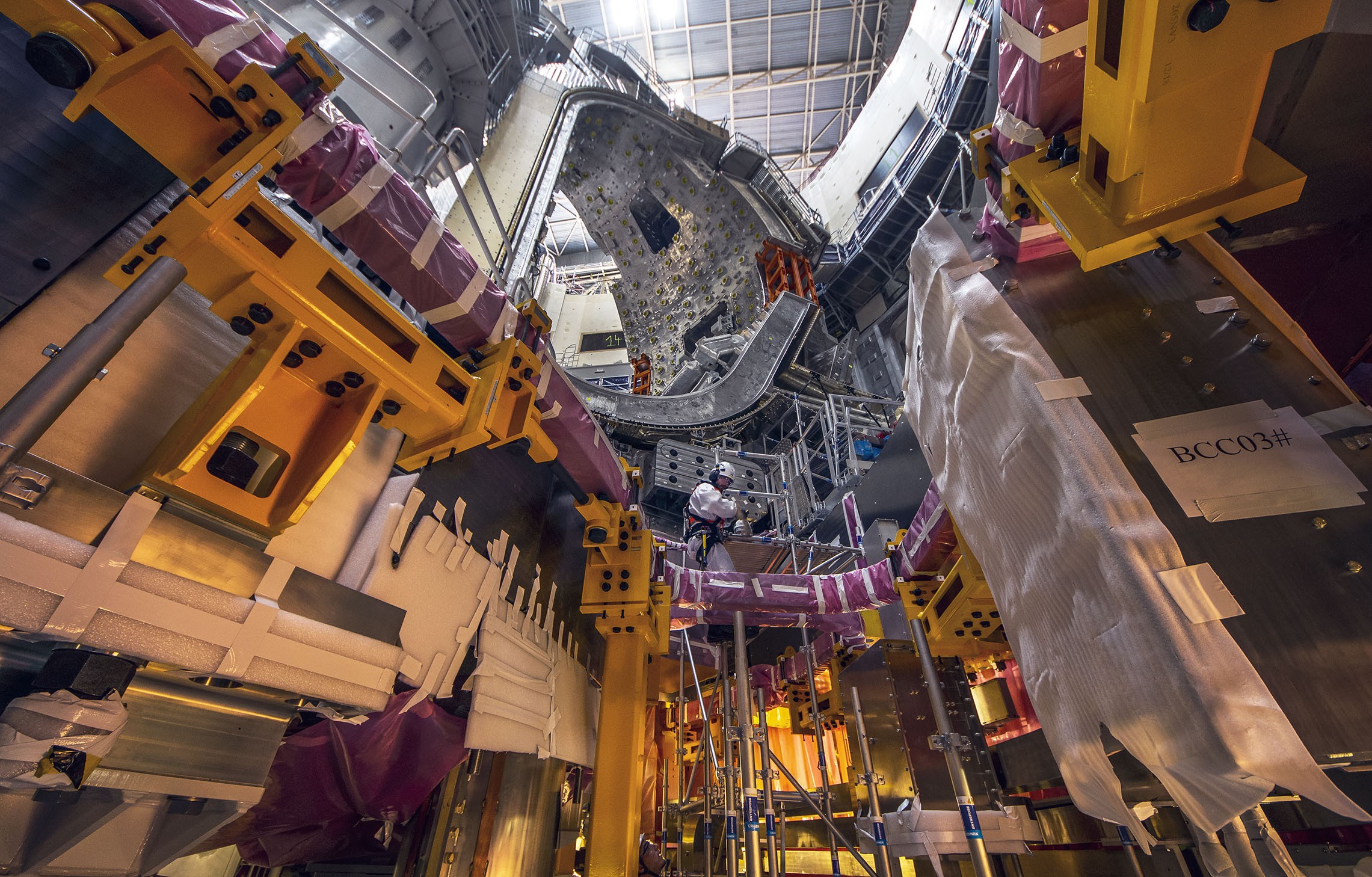 Coils being installed inside ITERs tokamak pit.