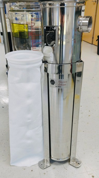 a white filtration bag next to a silver column