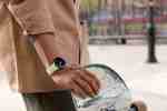 person wearing Google Pixel Watch, holding a skateboard