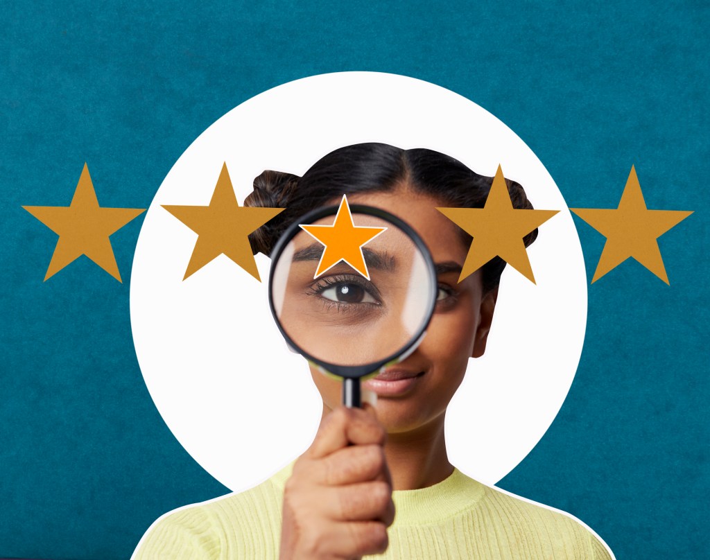 young woman looking at camera with magnifying glass at customer star ratings with blue background