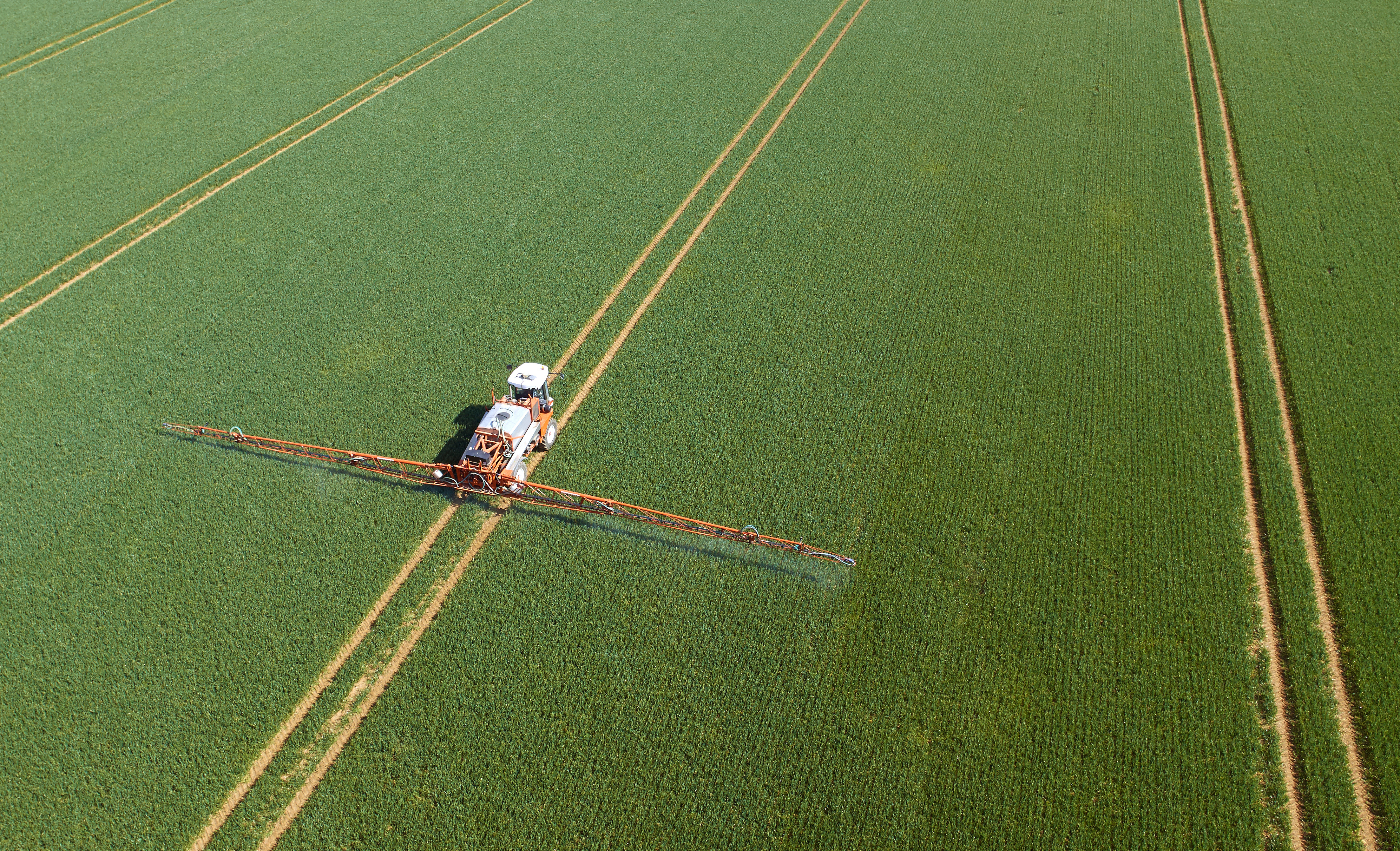 Crop sprayer in field aerial view;  agtech