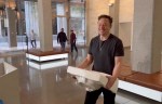 Elon Musk carries a sink into Twitter HQ