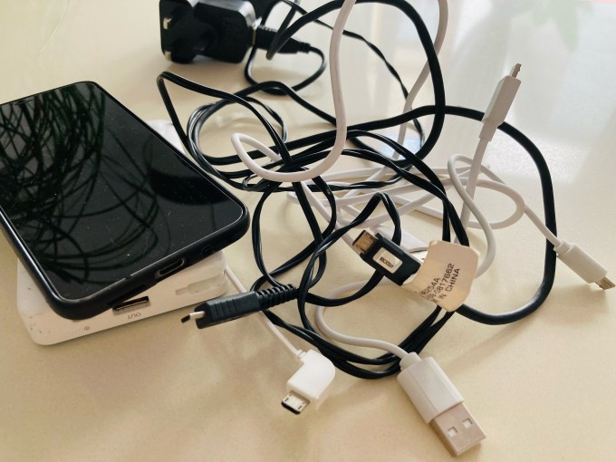 Proprietary smartphone charger cable mess