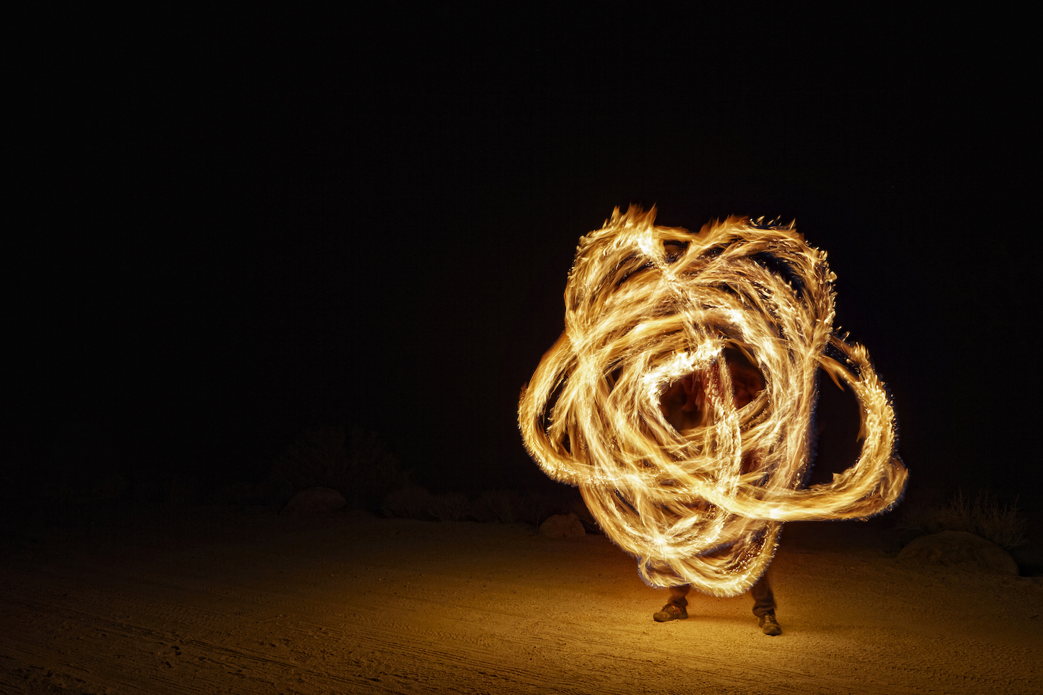 a fire poi spinner with a long exposure