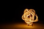 a fire poi spinner with a long exposure