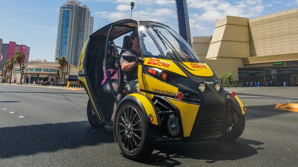 Arcimoto Fun Utility Vehicle in yellow with GoCar logo in Las Vegas