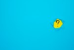 Image of a hole in a blue page revealing a question mark on a yellow background.