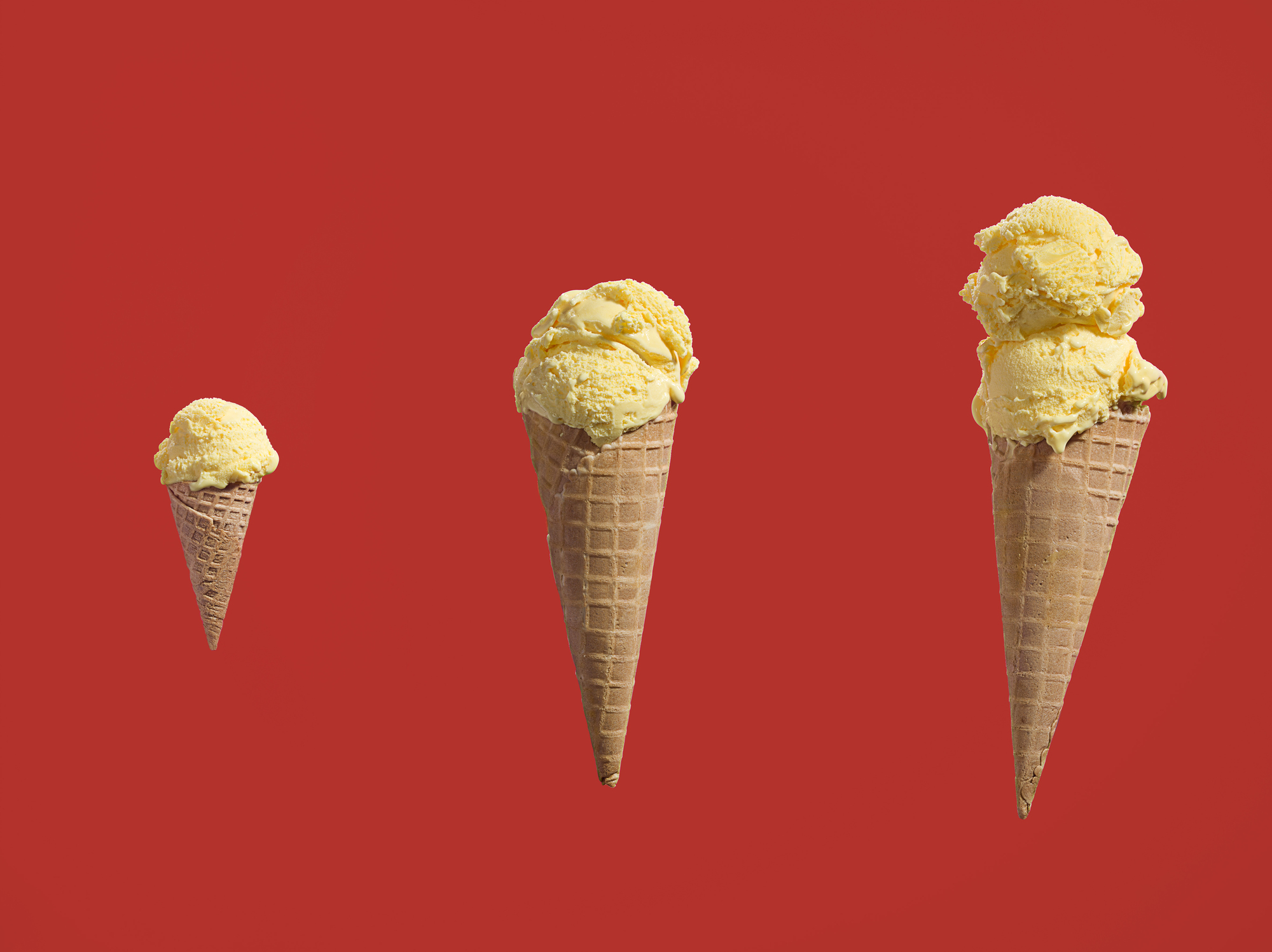 Row ice cream cones with different amounts of scoops