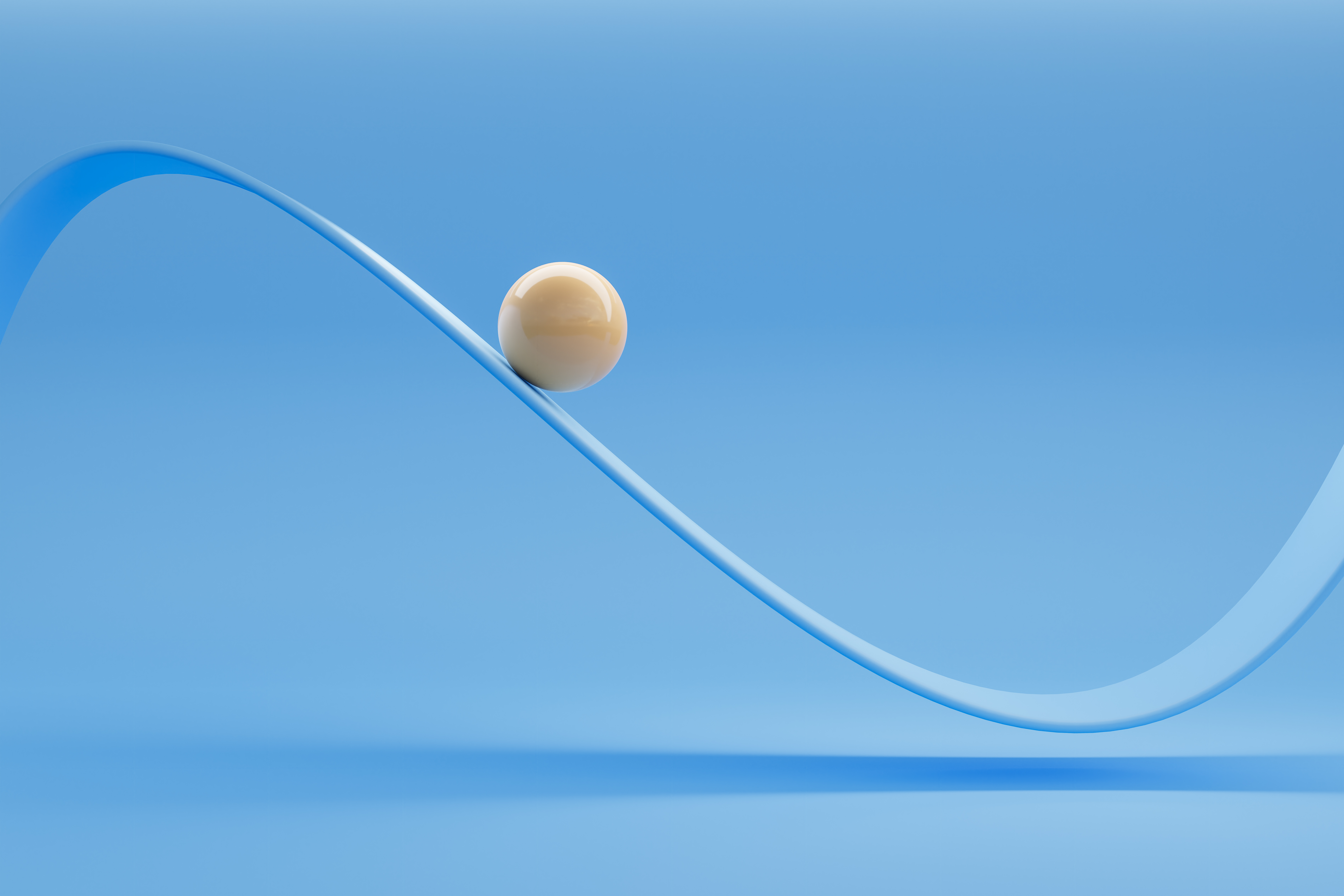 صورة لكرة خزفية بيضاء لامعة تتحرك على طول منحنى متأرجح على خلفية زرقاء.