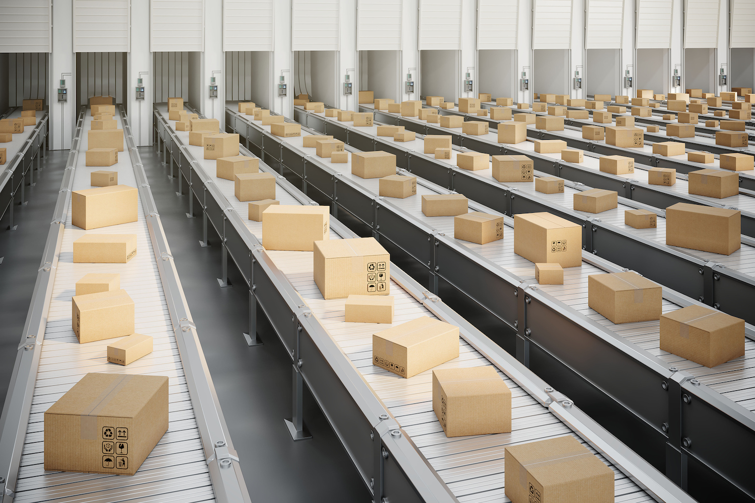 Boxes on conveyor belt to the truck loading dock in shipping distribution warehouse.