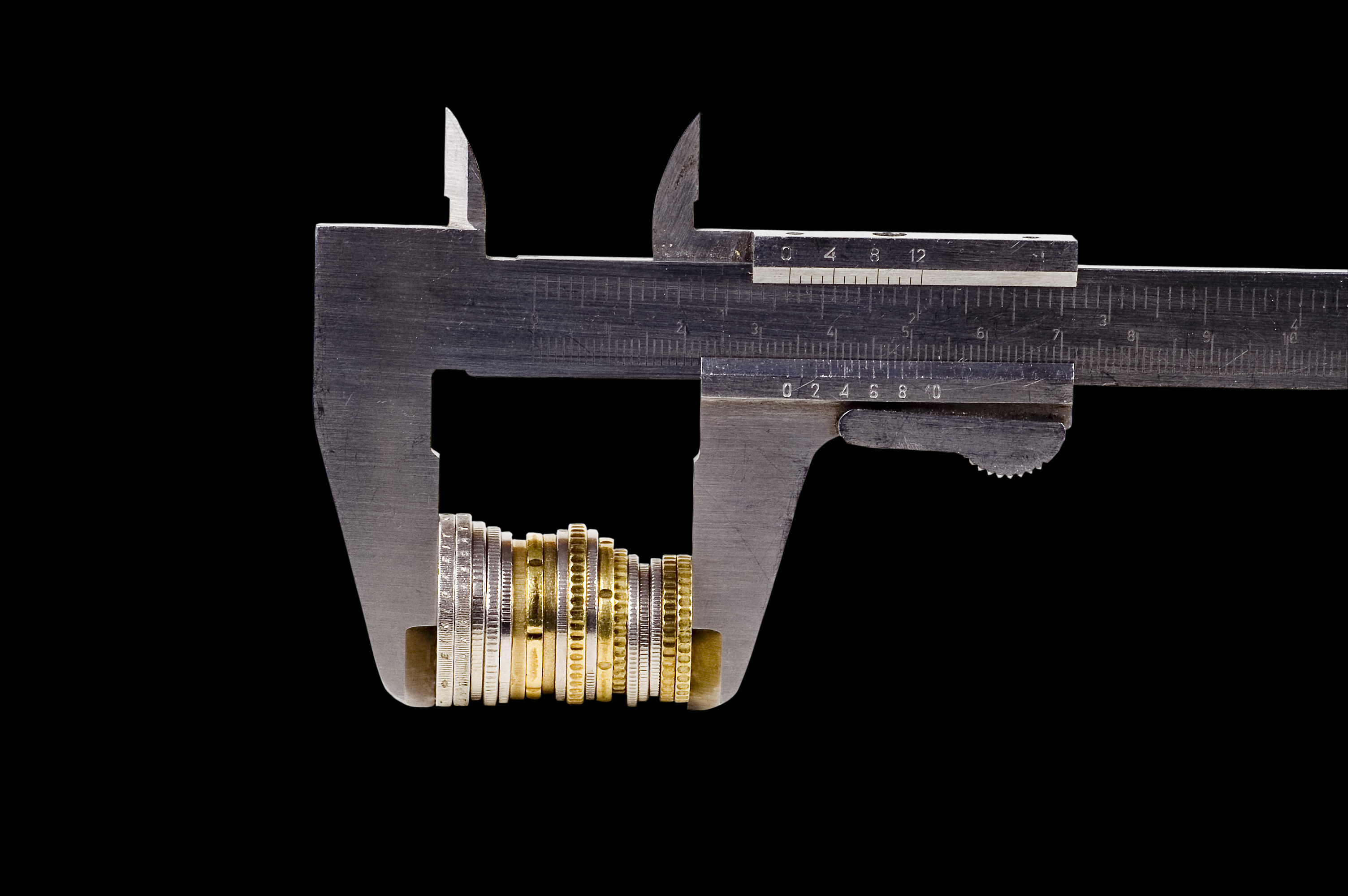 Vernier calipers measuring a stack of coins