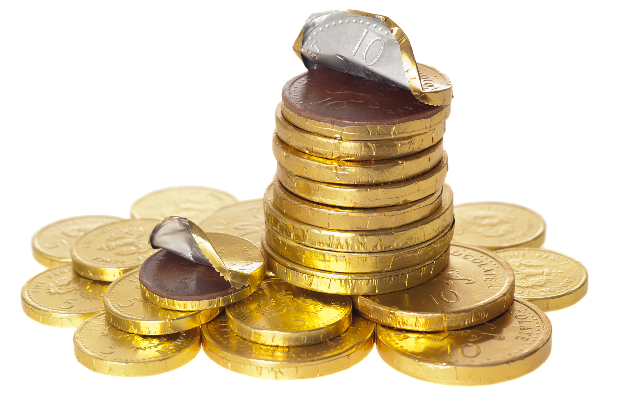 Chocolate money coins stacked on white