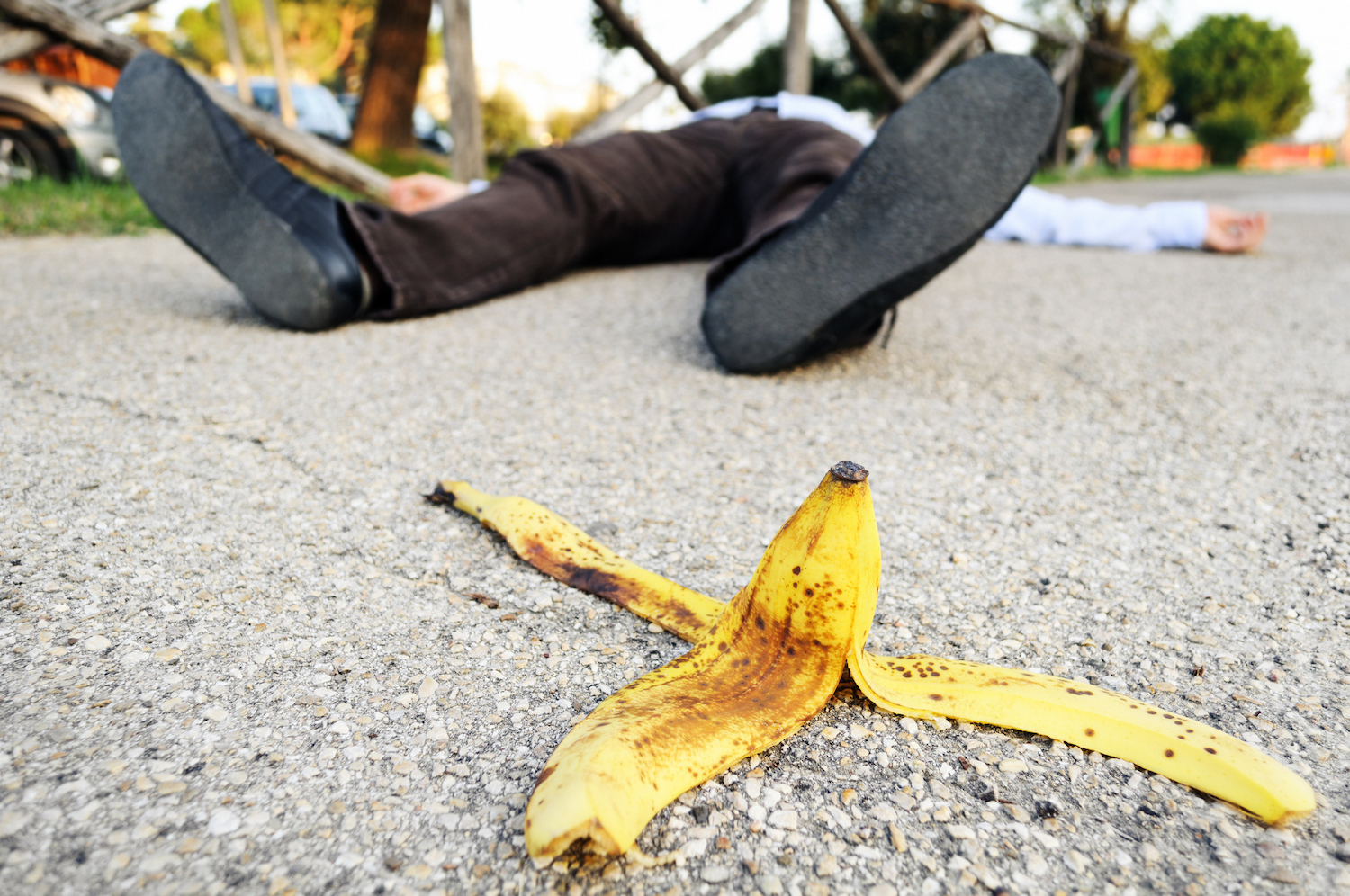 Man fell to the ground on a banana peel.
