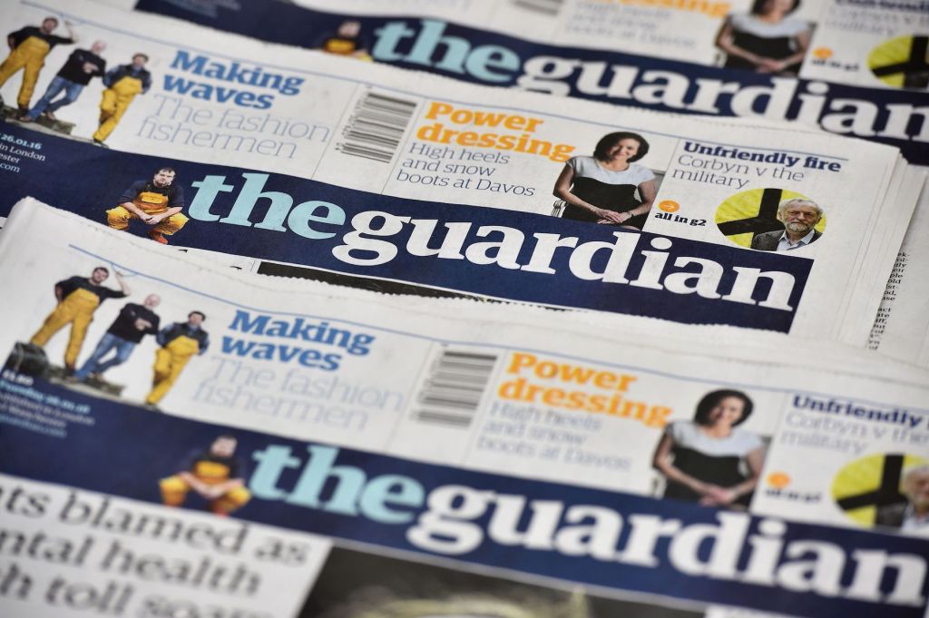 Several copies of The Guardian's newspaper stacked on top of one another.