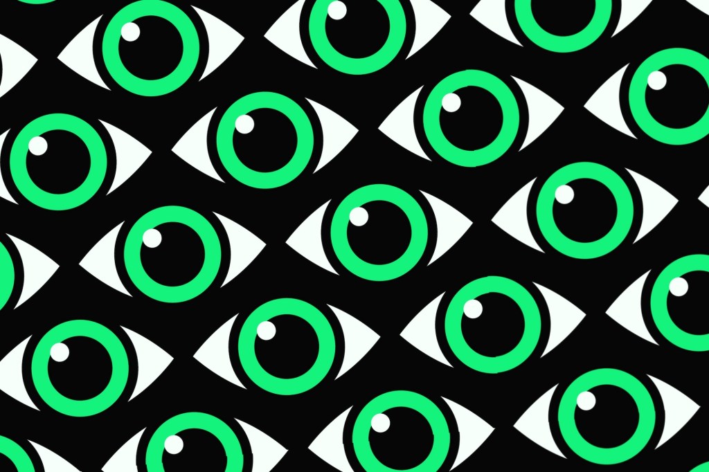 Green eyes with a white glint on a patterned black background.