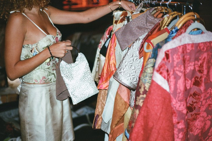 Curated Loop fashion rentals startup - image depicts a woman browsing a sample sale