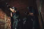 a photo of a team of police officers raiding a house